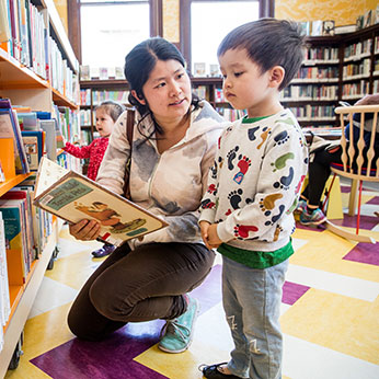 A mother showing her child a book. Links to Closely Held Business Stock A mother showing her child a book. Links to Closely Held Business Stock