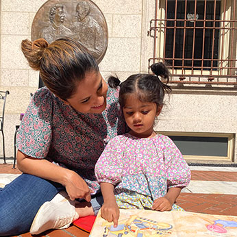 Mother and child reading a book. Links to What to Give Mother and child reading a book. Links to What to Give