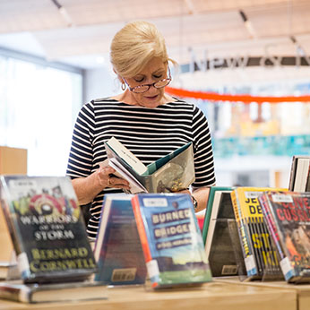 A woman reading a book. Links to Gifts That Protect Your Assets